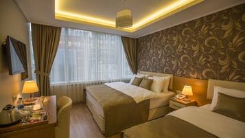 Standard Triple Room | Minibar, in-room safe, desk, soundproofing
