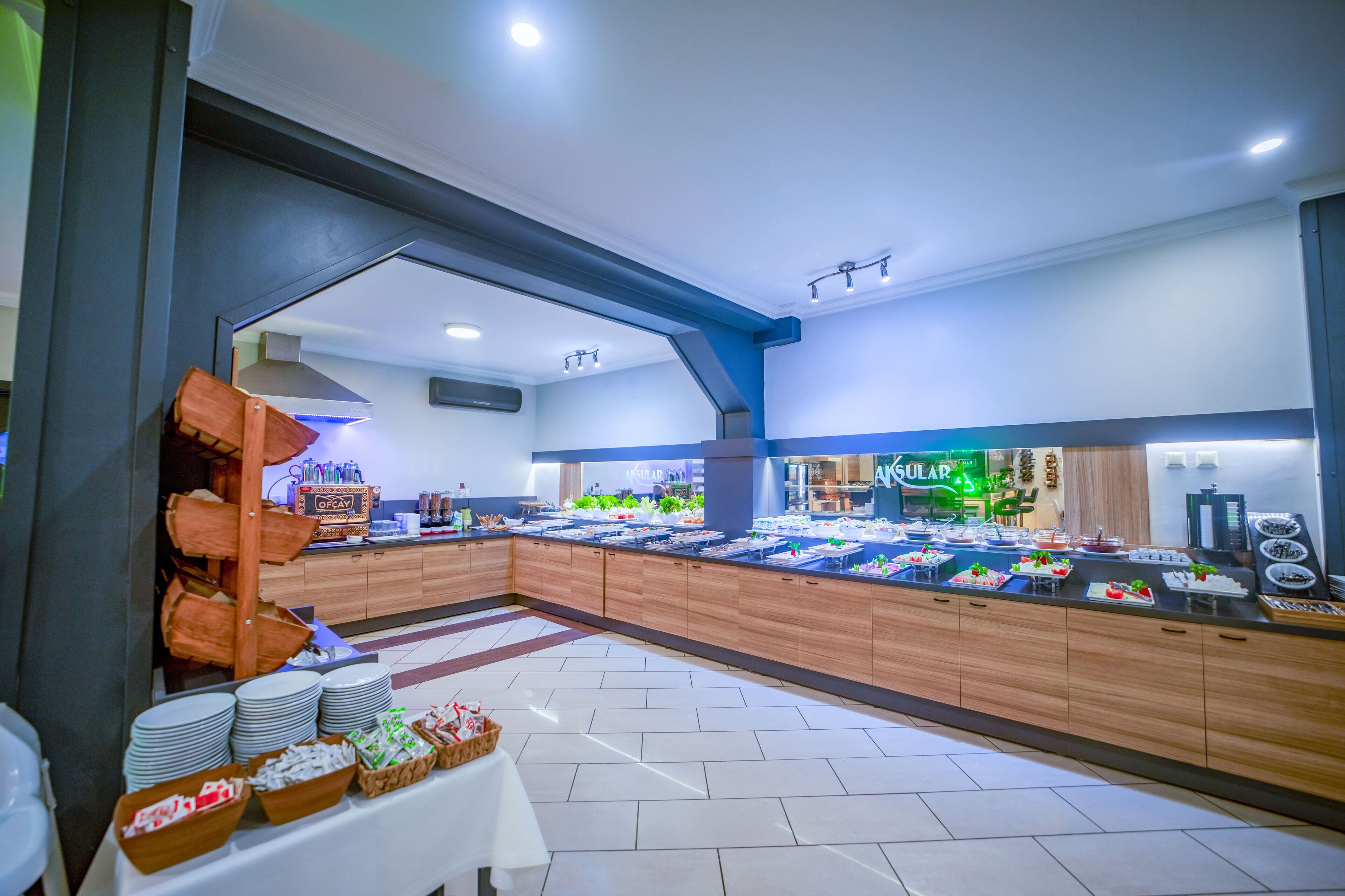 A buffet area with a variety of food items and a counter with beverages.