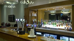 A bar area with multiple taps, a pitcher, and a refrigerated display.
