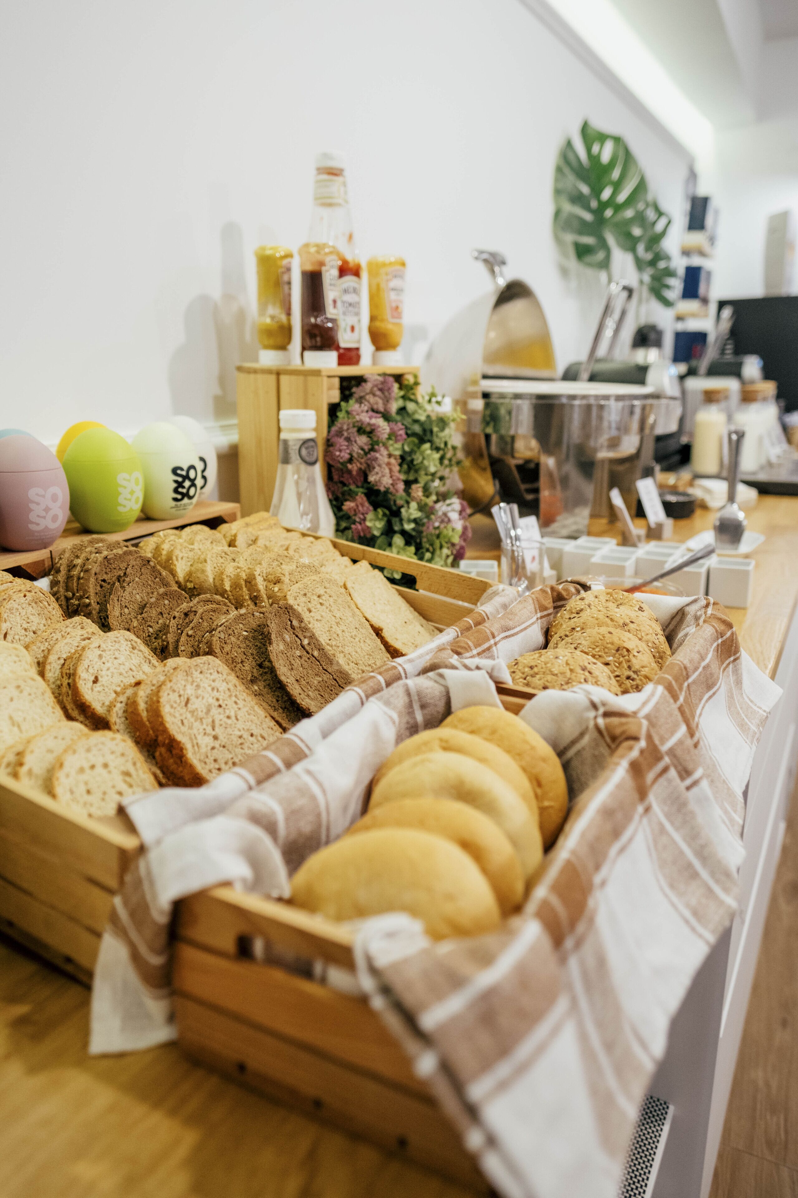 A bakery display with various breads and pastries.