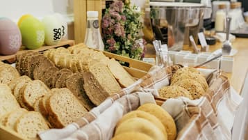 A bakery display with various breads and pastries.