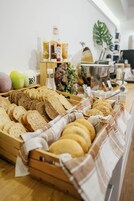 A bakery display with various breads and pastries.