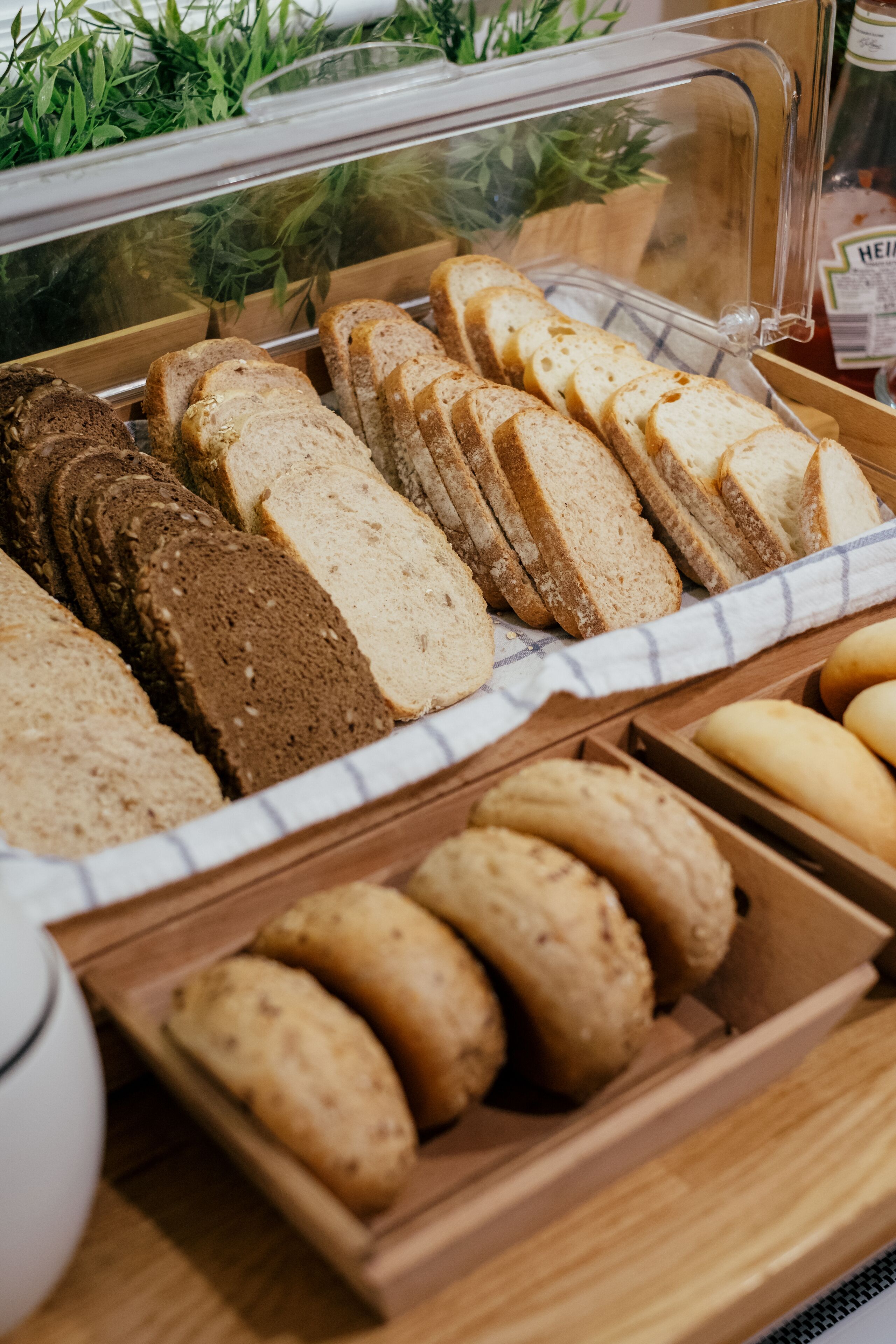 A bakery display with various types of bread and pastries.