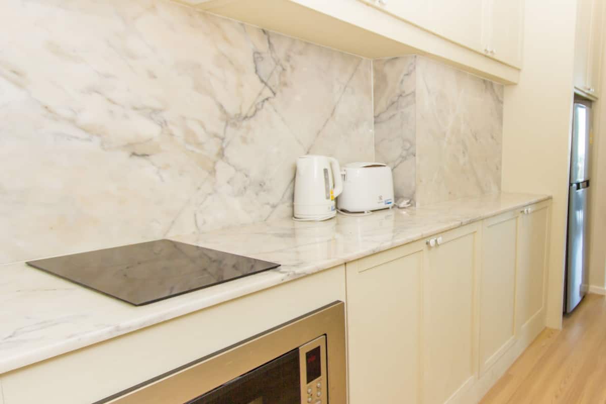 standard queen room | private kitchen | full-sized fridge, microwave, stovetop, cookware/dishes/utensils