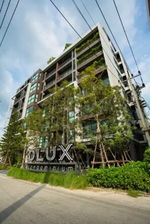 A modern building with a sign reading "DLUX".