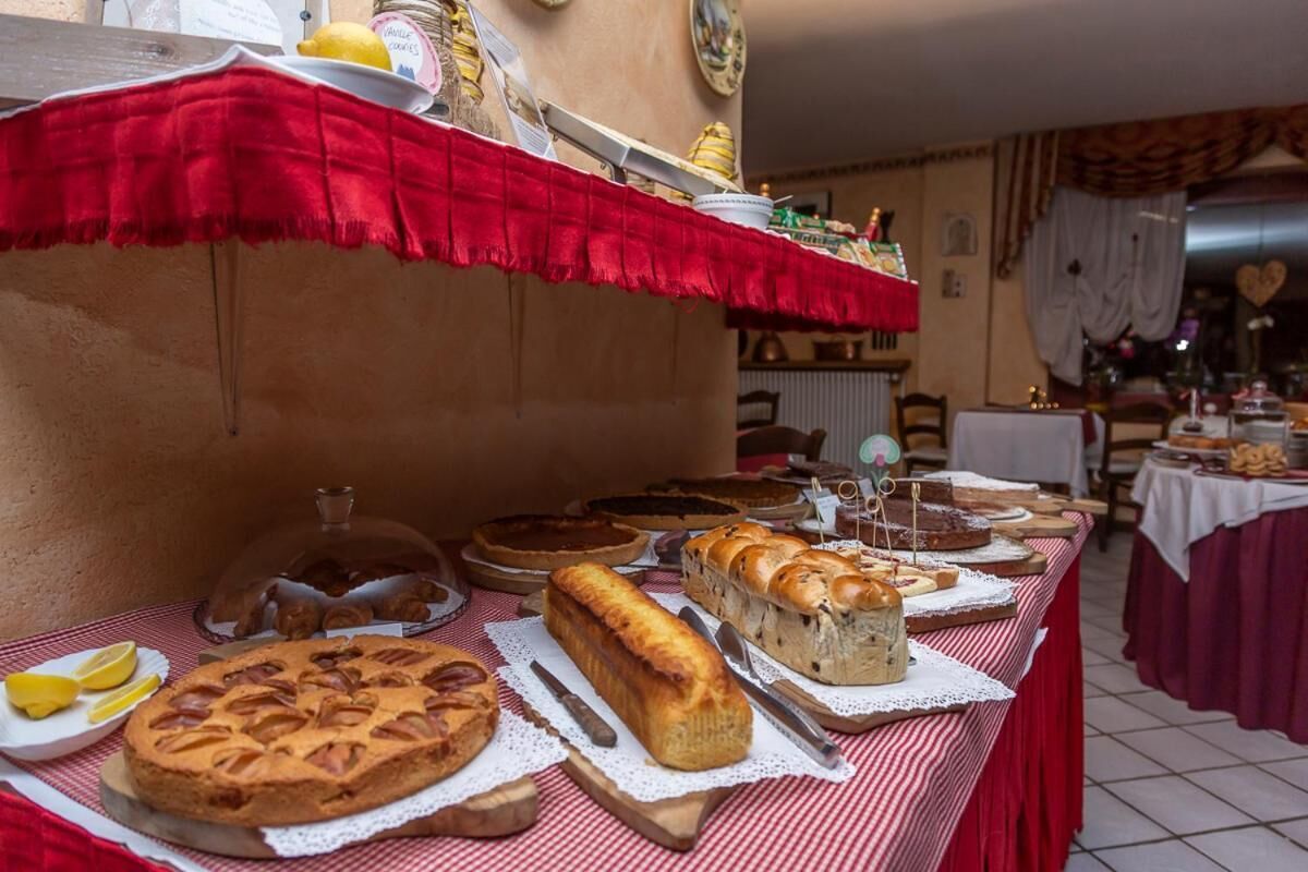 A buffet table with various baked goods and pastries.