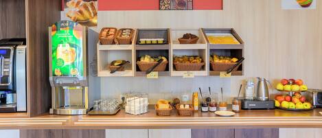 A breakfast buffet with various food items and a coffee machine.