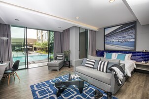 Grand Deluxe Pool Access | Minibar, in-room safe, desk, blackout drapes