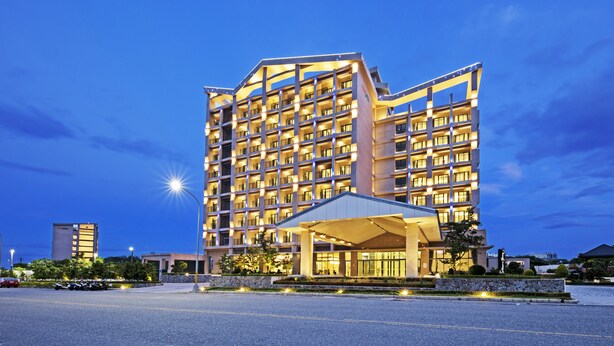 A multi-story hotel with a modern design, featuring a covered entrance and a parking area in front. - Formosa Naruwan Galaxy Hotel Taitung (Taitung)