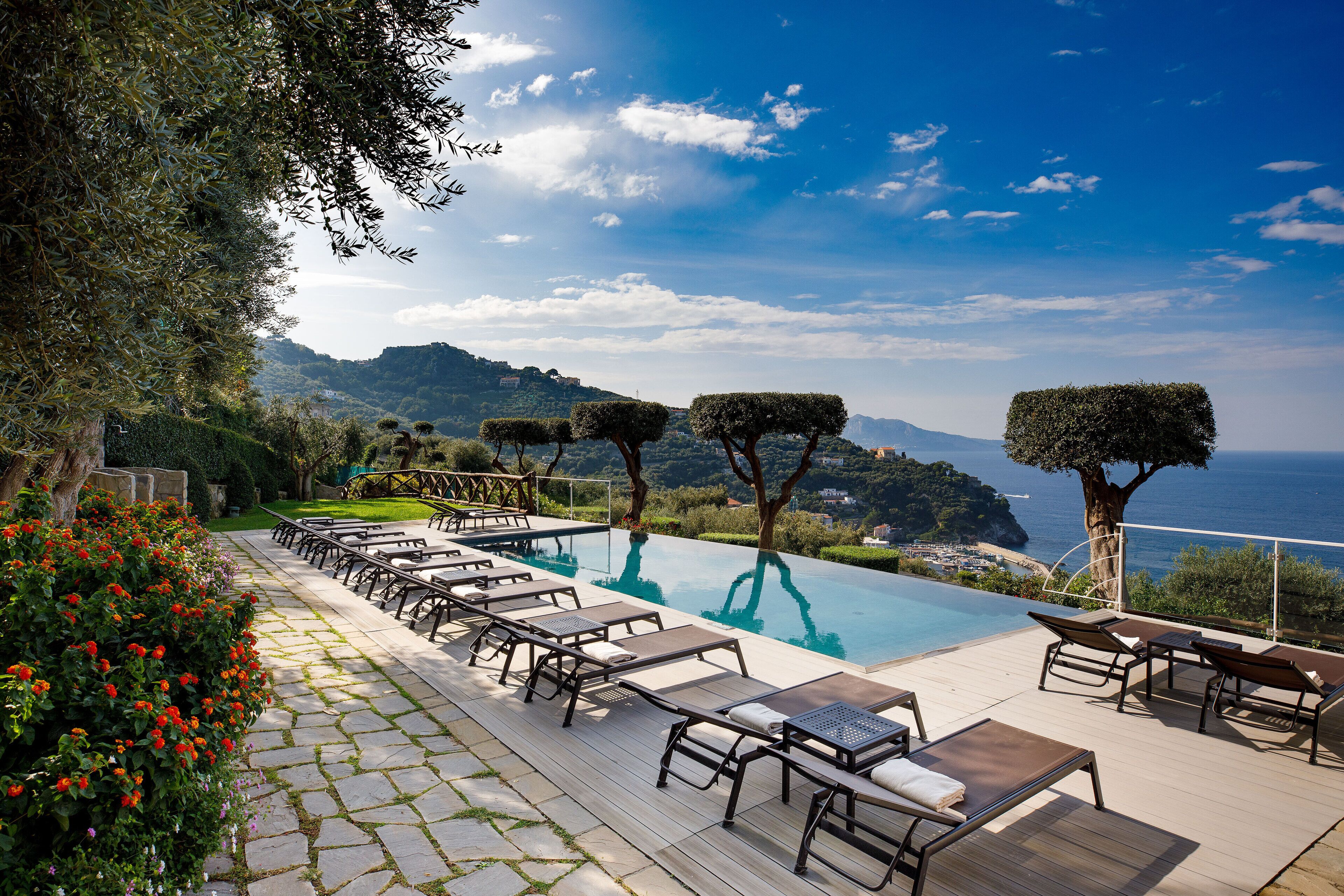 seasonal outdoor pool, open 9 am to 7 pm, pool umbrellas, pool loungers