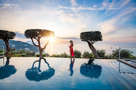 Seasonal outdoor pool, open 9 AM to 7 PM, pool umbrellas, sun loungers. Villa Fiorella Art Hotel