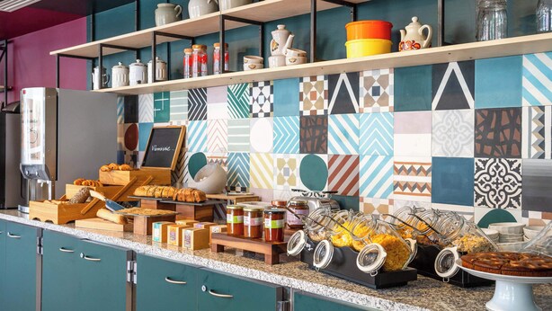 A breakfast buffet with various food items and condiments. - B&B HOME Paris Mairie de Saint-Ouen (Saint-Ouen)