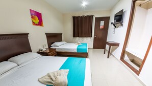 A hotel room with two beds, a TV mounted on the wall, a small table, and a door with a sign. - Hotel Villamar (Veracruz)