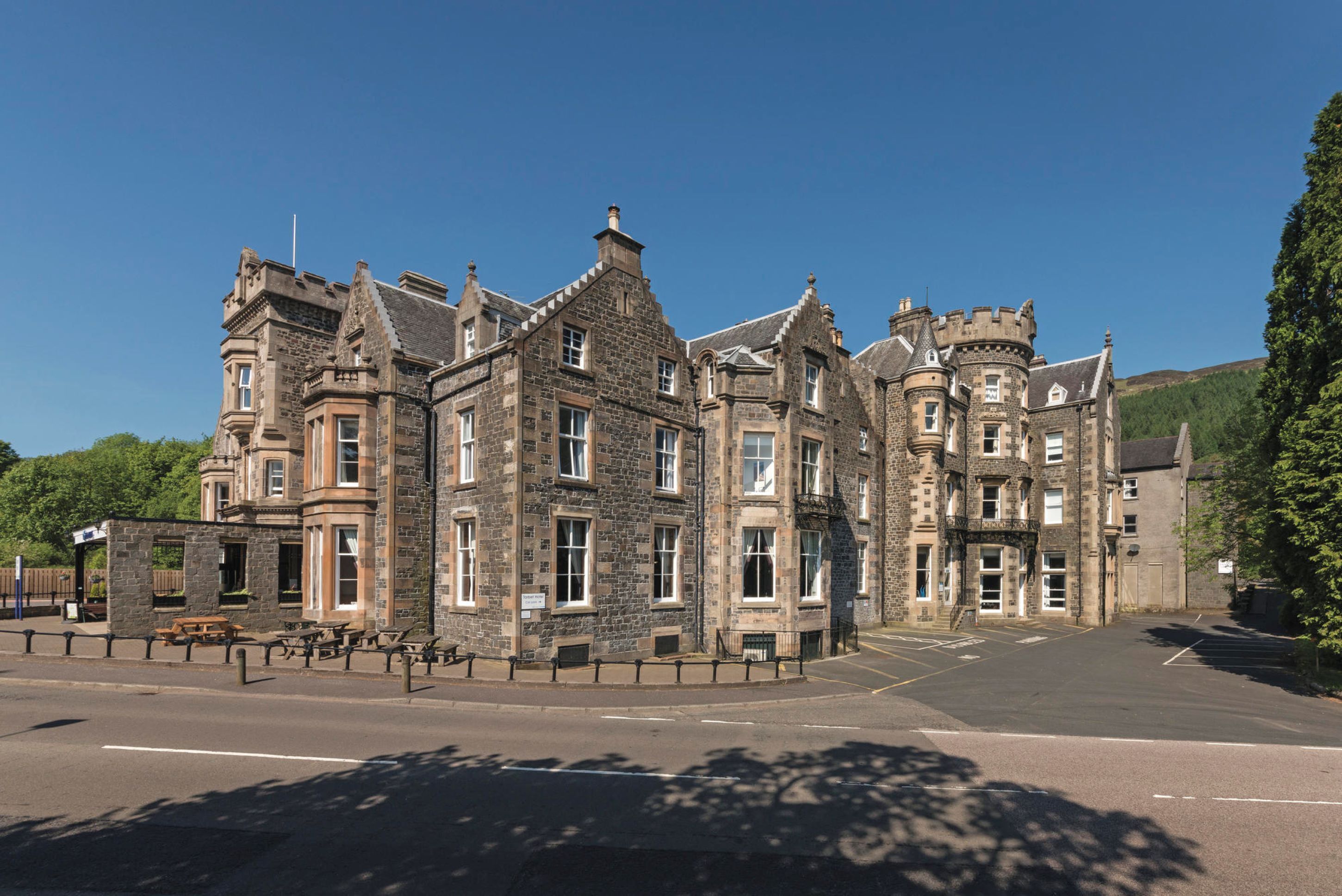 A historic stone building with multiple towers and a central entrance.