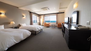 A hotel room with two beds, a desk with a telephone, a television, and a view of the sea. - Naruto Kaigetsu Bettei Taimaru Kaigetsu (Naruto)