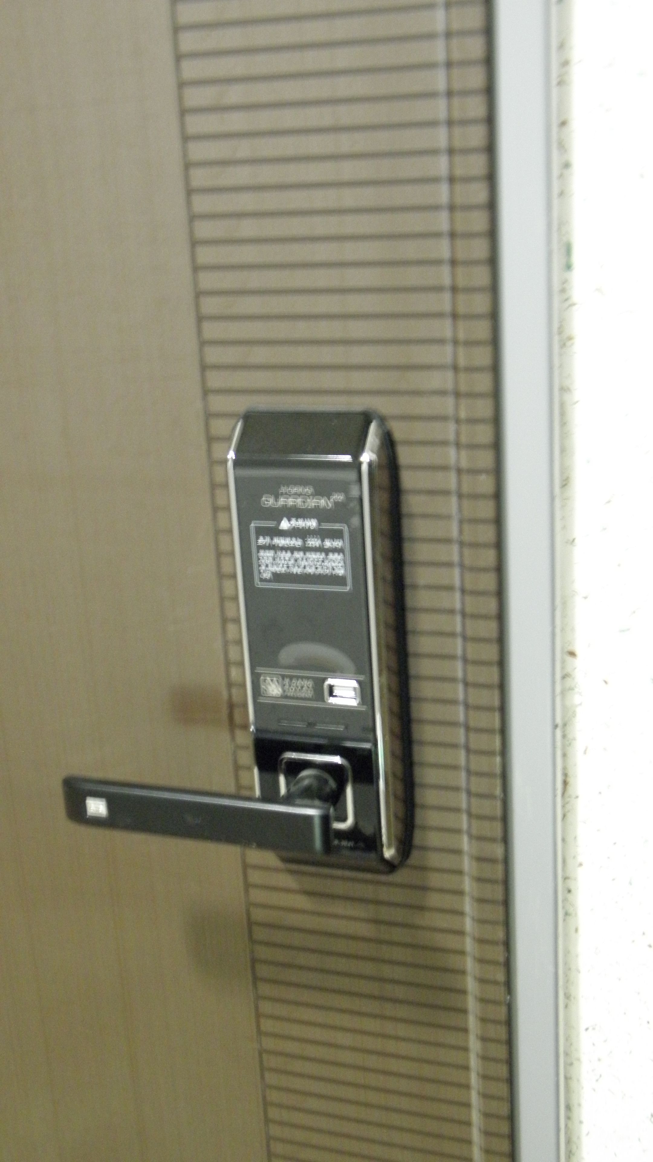 A door with a keycard reader and a keycard slot.
