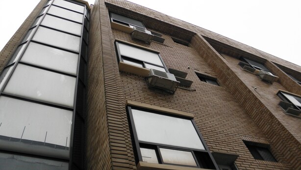 A multi-story building with large windows and air conditioning units. - Good Morning Vil Residenece Inn (Gumi)