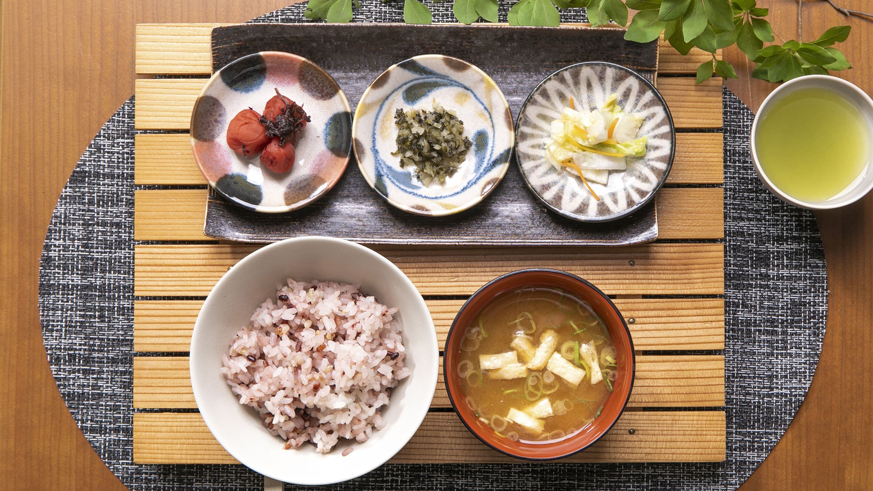 A tray with various dishes including rice, soup, and vegetables.