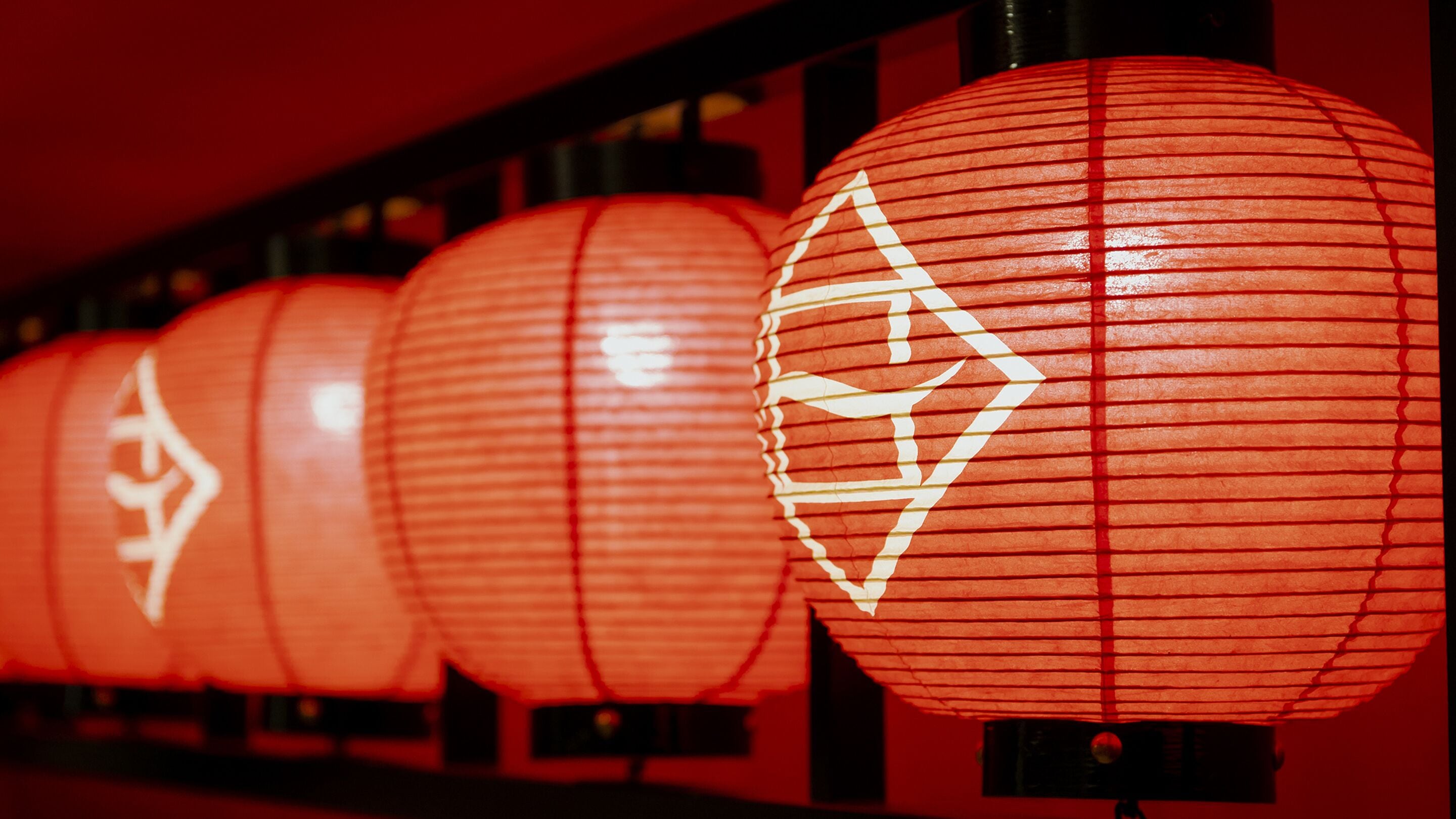 A row of red lanterns with white patterns.