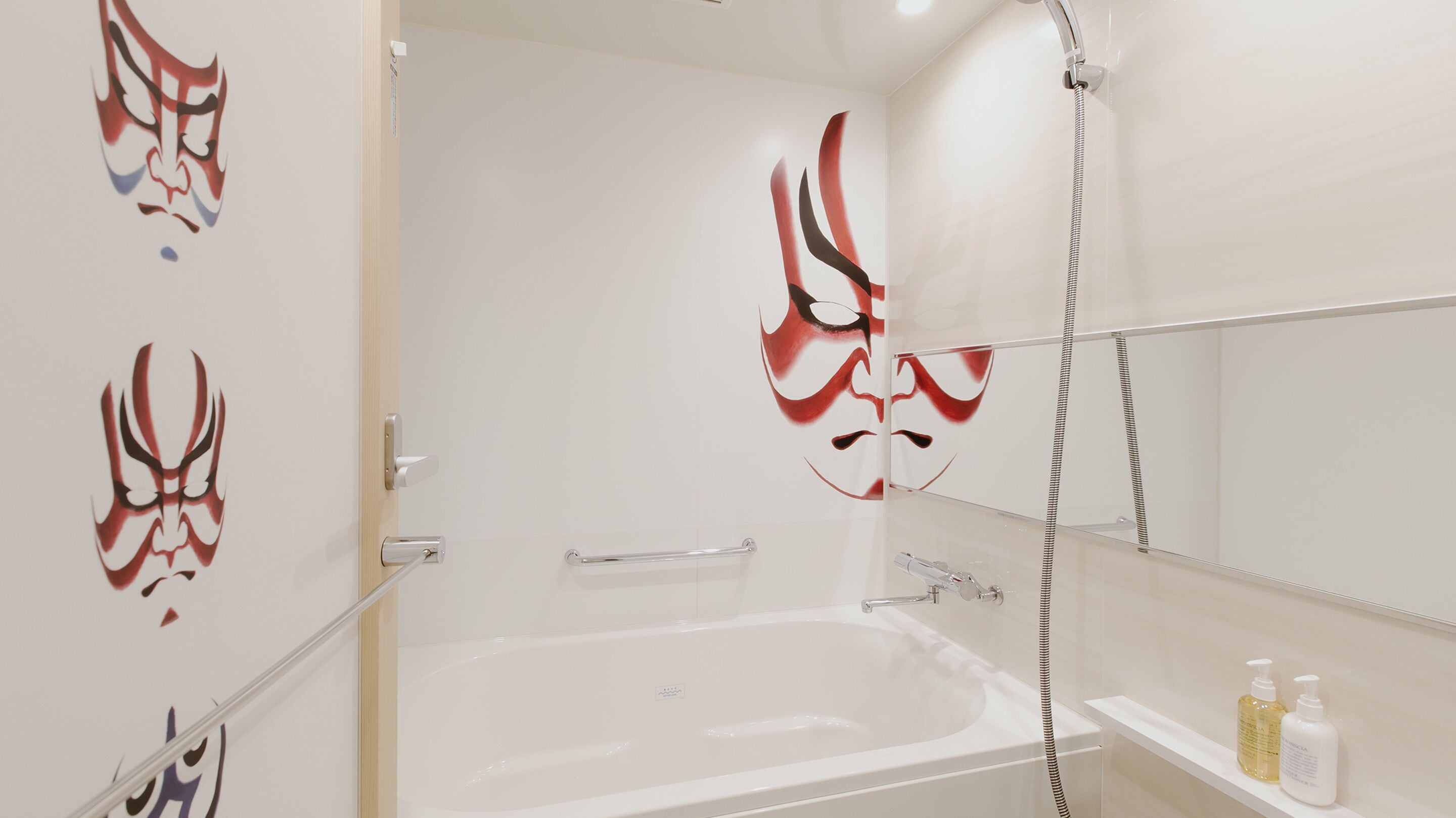 A bathroom with a bathtub, a shower, and a toilet. There are decorative wall stickers and a shelf with toiletries.