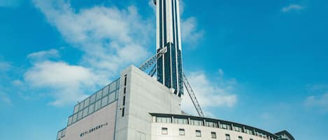 A modern building with a prominent tower and multiple windows.