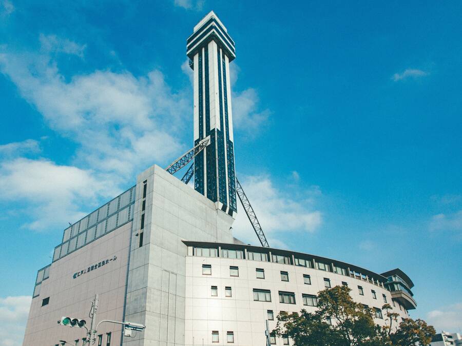 A modern building with a prominent tower and multiple windows.