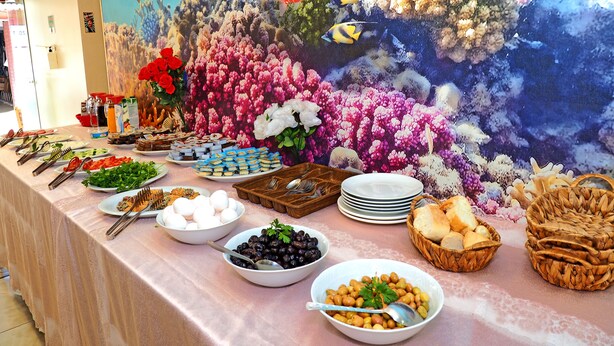 A buffet table with various food items and a backdrop of a coral reef with fish. - Seyri Istanbul Hotel (Istanbul)