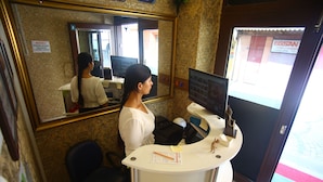 A reception desk with a computer monitor, a telephone, and a mirror. There is a sign on the wall and a window with a view of the street. - Seyri Istanbul Hotel (Istanbul)