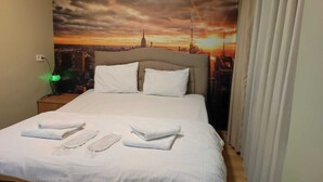 A hotel room with a bed, pillows, and neatly folded towels. - Seyri Istanbul Hotel (Istanbul)