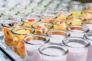 A tray of various food items in glass jars, including fruits and a pink dessert. - Felbermayer Hotel & AlpineSpa - Montafon (Gaschurn)