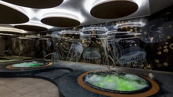 Relax in a serene spa area with multiple hot tubs surrounded by a dark-colored rim.