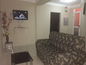 Deluxe Suite, 1 King Bed | Living area | 21-inch flat-screen TV with satellite channels, TV - Secrets Hotel (Accra)