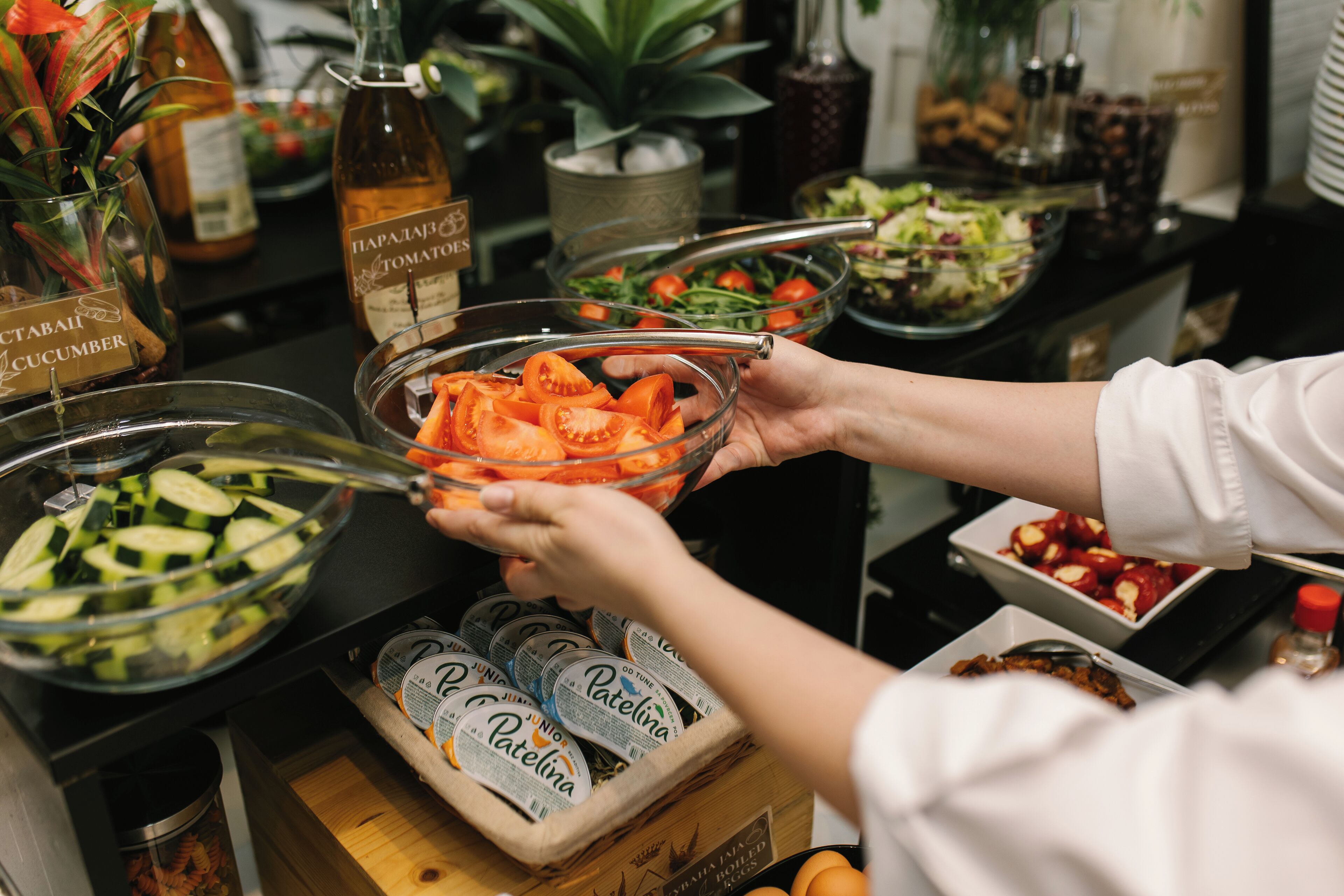 A buffet setup with various food items and condiments.
