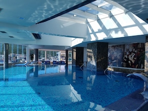 Indoor pool, pool umbrellas, pool loungers