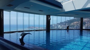 Indoor pool, pool umbrellas, pool loungers