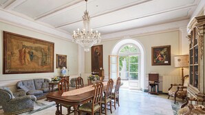 A formal dining room with a large table, chairs, and a chandelier. - Agriturismo Villa Augusto (Cortona)