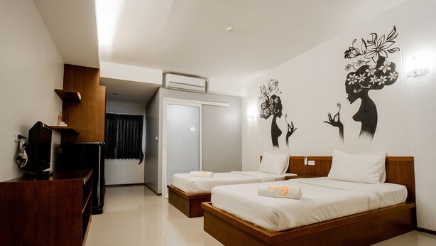 A hotel room with two beds, a wooden dresser, an air conditioning unit, and a wall mural. - Fun-D City View (Khon Kaen)