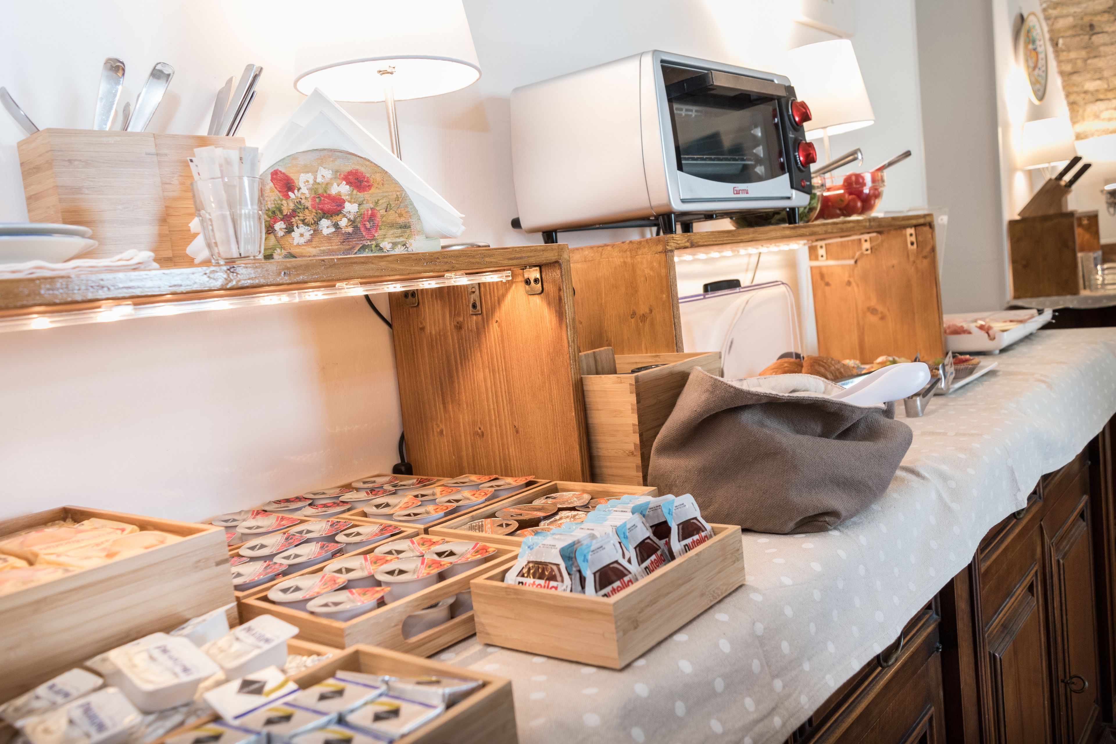 A buffet area with various food items and a television.