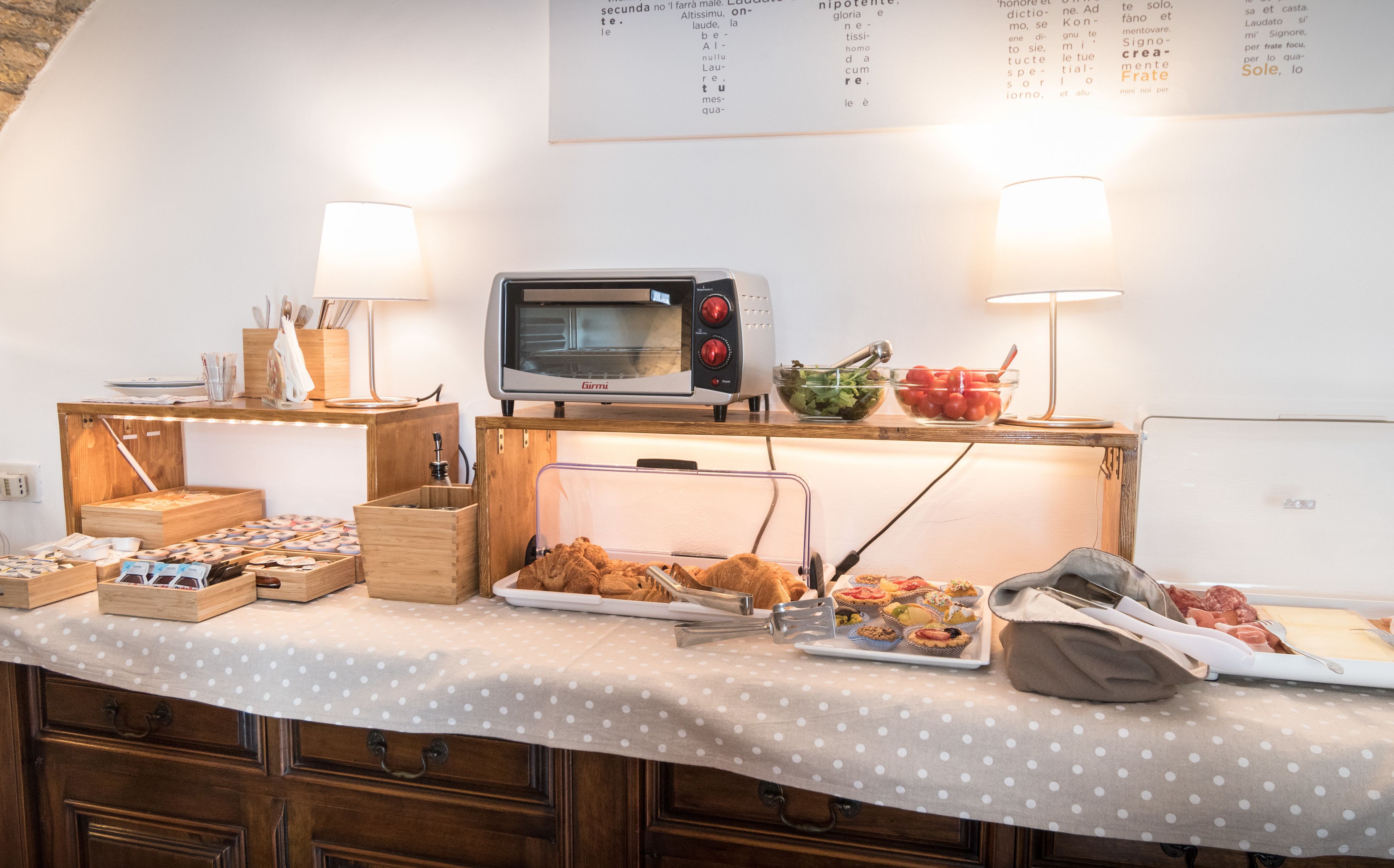 A buffet setup with a variety of food items, a microwave, and a menu board on the wall.