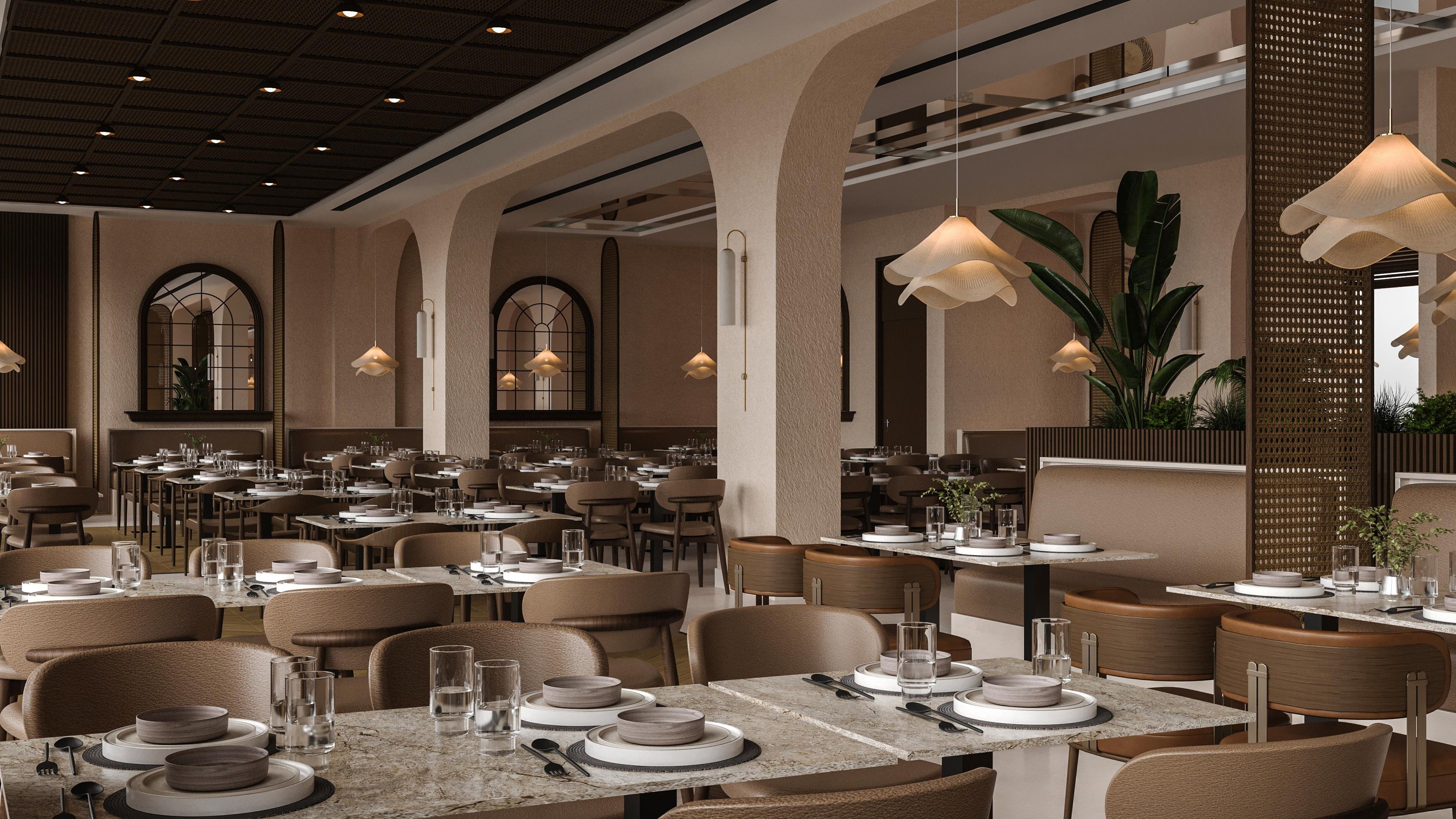 Un restaurant spacieux doté de nombreuses tables, de chaises et de luminaires suspendus.