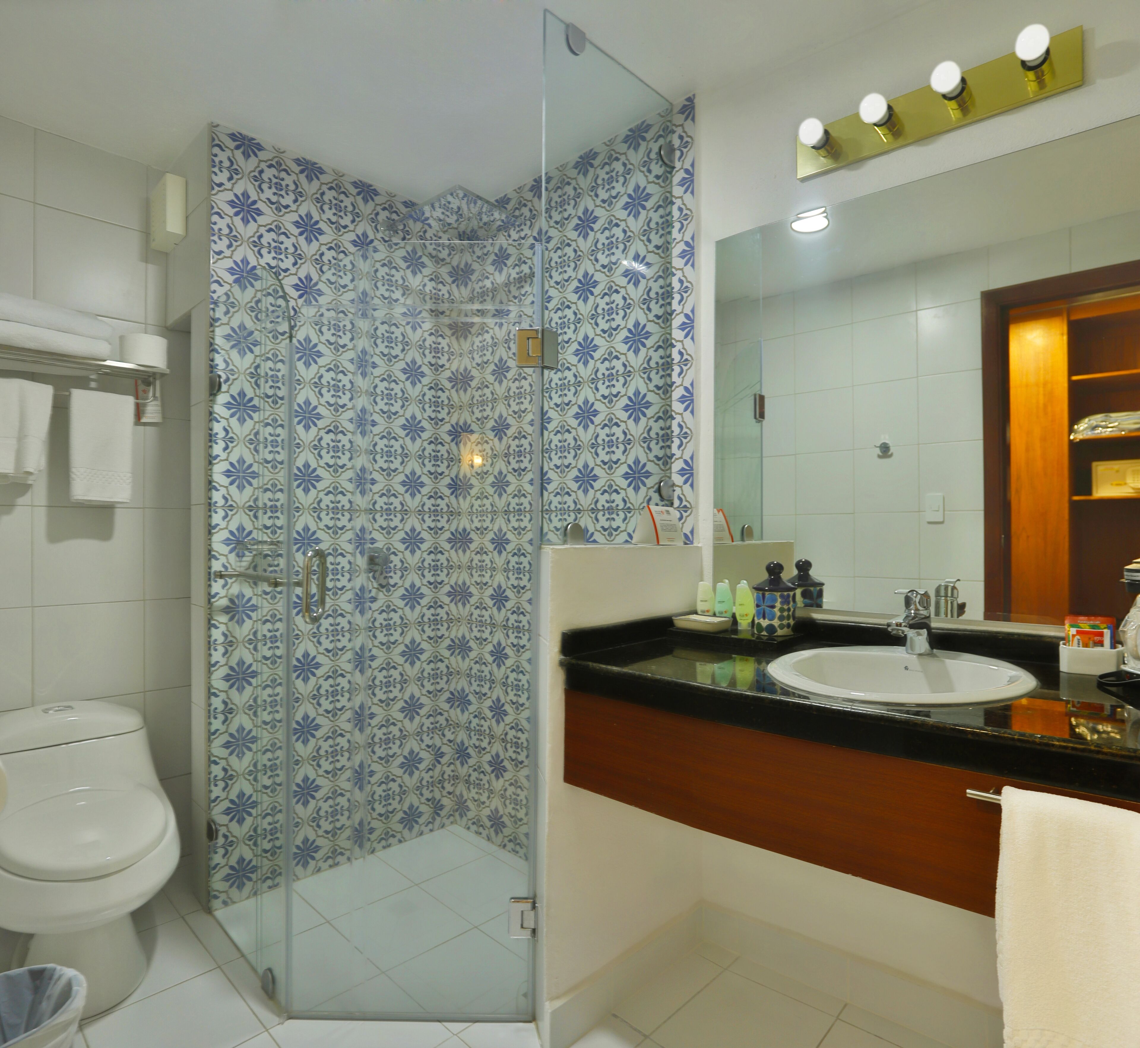 A bathroom with a shower, toilet, and sink.
