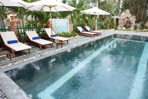 Outdoor pool, a waterfall pool, pool loungers