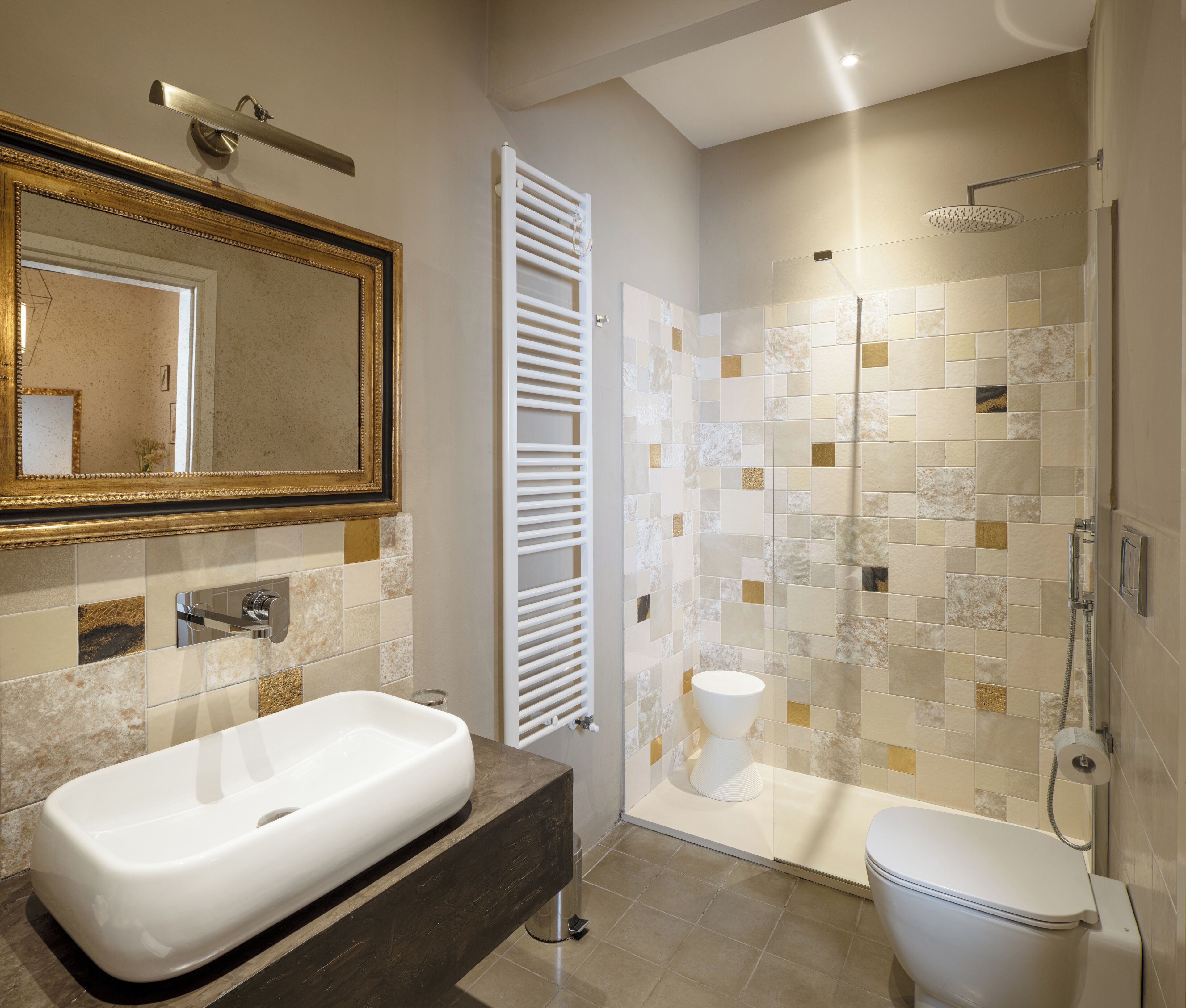 A modern bathroom with a large mirror, a bathtub, a toilet, and a shower area.