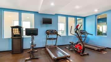 A gym with treadmills, an elliptical, and a stationary bike.