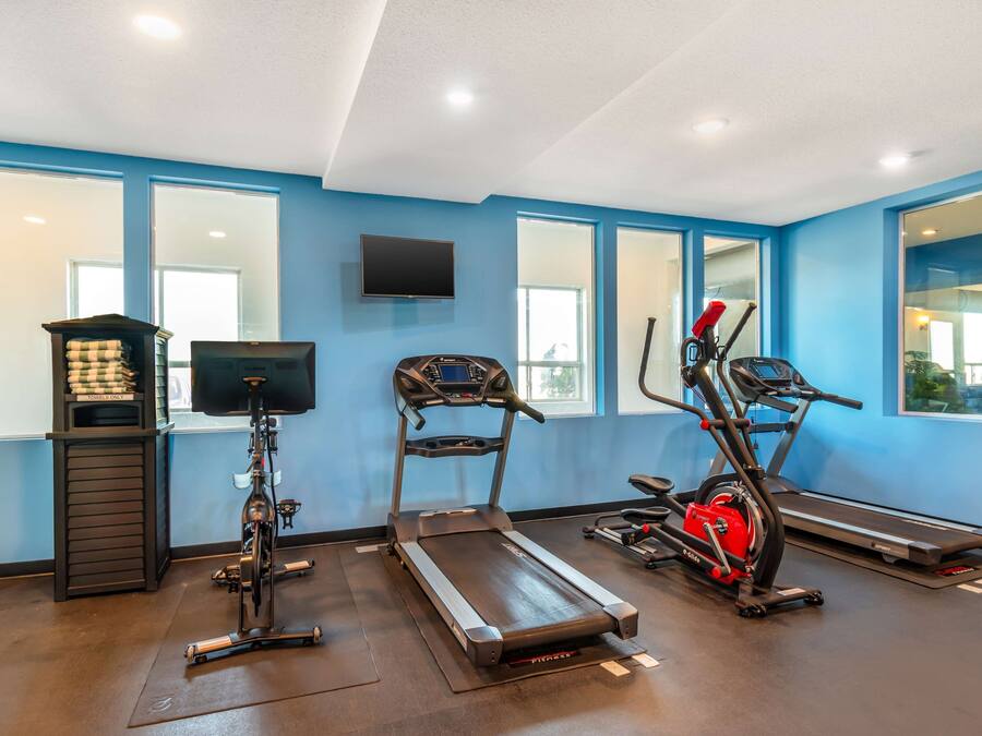 A gym with treadmills, an elliptical, and a stationary bike.