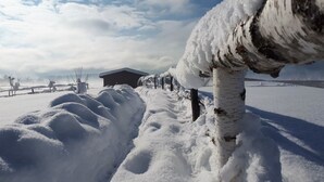 A snow-covered landscape with a wooden structure in the background. - Ranch Terra (Rakovica)