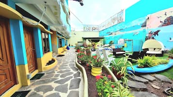 Stroll through a charming courtyard surrounded by colorful buildings with traditional doors and vibrant murals.