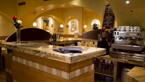 A bar area with a marble countertop, a coffee machine, and a chalkboard menu. - Hotel Alter Telegraf (Graz)