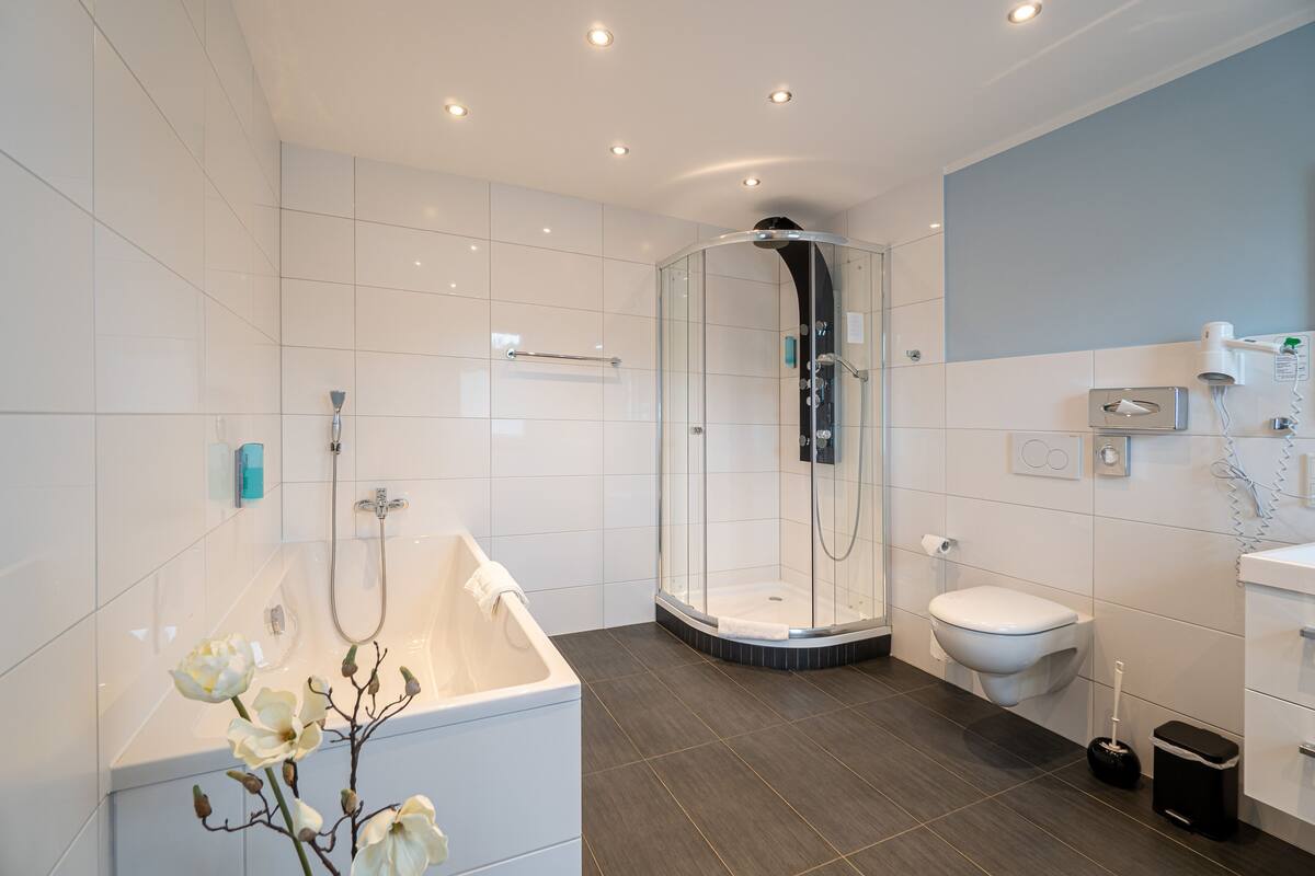 superior double room | bathroom | shower, hair dryer, towels, toilet paper