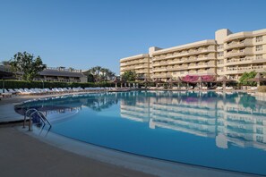 A hotel with a swimming pool, sun loungers, and a multi-story building with balconies. - Sindbad Club (Hurghada)